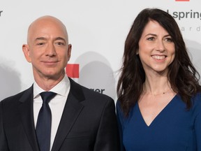 In this file photo taken on April 24, 2018 Amazon CEO Jeff Bezos and his wife MacKenzie Bezos  poses as they arrive at the headquarters of publisher Axel-Springer where he will receive the Axel Springer Award 2018 in Berlin. (JORG CARSTENSEN/AFP/Getty Images)