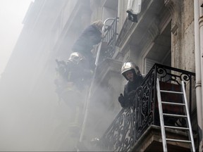 A person is evacuated by firefighters from an apartment after the explosion of a bakery on the corner of the streets Saint-Cecile and Rue de Trevise in central Paris on January 12, 2019.(THOMAS SAMSON/AFP/Getty Images)