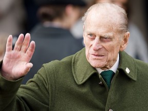 In this file photo taken on Dec. 25, 2012, Prince Philip, Duke of Edinburgh waves to well-wishers as he leaves following the Royal family Christmas Day church service at St. Mary Magdalene Church in Sandringham, Norfolk, in the east of England.