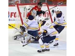 Buffalo Sabres Linus Ullmark makes a save on Garnet Hathaway of the Calgary Flames during NHL hockey at the Scotiabank Saddledome in Calgary on Wednesday. Photo by Al Charest/Postmedia