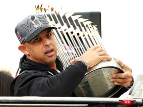 Boston Red Sox manager Alex Cora holds the World Series trophy during the team's victory parade on October 31, 2018 in Boston. (Adam Glanzman/Getty Images)