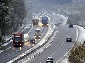 Cars and trucks drive on Autobahn A96 near Penzing, 24 October 2003. (JOHANNES SIMON/AFP/Getty Images)
