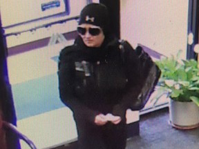 A woman is seen in a screenshot from surveillance video at the Fall River Municipal Credit Union in Fall River, Mass.