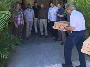 Former President George W. Bush delivers pizza to his Secret Service detail Friday. (Facebook photo)