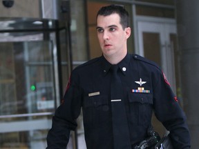 Calgary Police Const. Stephen Cook leaves Calgary Courts on Dec. 18, 2013.