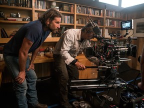 This image released by Warner Bros. Pictures shows director/co-writer/producer Bradley Cooper, left, and camera operator Scott Sakamoto on the set of "A Star is Born."