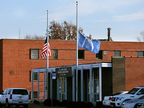 Flags fly at half-staff in front of the St. Louis Police Officers Association on Thursday, Jan. 24, 2019, following the shooting death of a police officer. (Robert Cohen/St. Louis Post-Dispatch via AP)