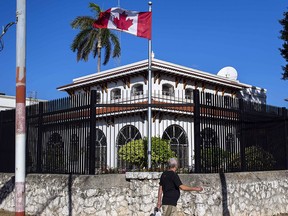 A man walks beside Canada's embassy in Havana, Cuba, on April 17, 2018. (THE CANADIAN PRESS/AP, Desmond Boylan)