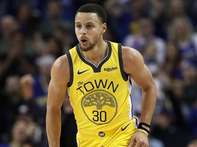 Stephen Curry of the Golden State Warriors reacts after making  basket against the New York Knicks at Oracle Arena on Jan. 8, 2019 in Oakland, Calif.