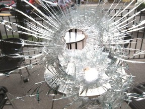 Bullet hole in the window of a Second Cup on Danforth Ave on Monday, July 23, 2018.