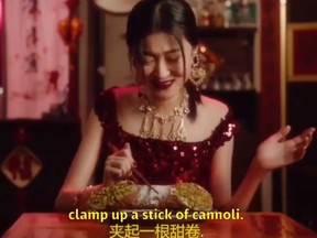 Model Zuo Ye appeared in a Dolce & Gabbana ad attempting to eat a giant version of a cannoli pastry using chopsticks, sparking backlash. (Instagram screengrab)