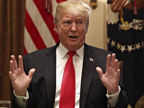 U.S. President Donald Trump gestures while speaking about tariffs, Thursday, Jan. 24, 2019, in the Cabinet Room of the White House in Washington.
