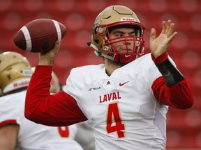 Laval University Rouge Et Or quarterback Hugo Richard throws the ball during first half U Sports Mitchell Bowl football action against the University of Calgary Dinos in Calgary, Saturday, Nov. 18, 2017.