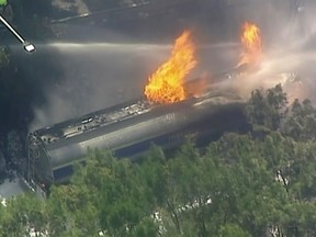 In this image made from a video, flames rise from a gasoline tanker on a highway in Wollongong, Australia Friday, Jan. 4, 2019.