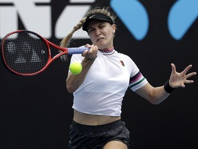 Eugenie Bouchard hits a return to Peng Shuai during their match at the Australian Open in Melbourne, Australia, Tuesday, Jan. 15, 2019. (AP Photo/Mark Schiefelbein)