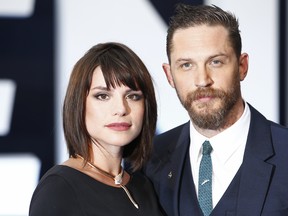 Tom Hardy and his wife Charlotte Riley pose for pictures on the red carpet after arriving to attend the world premier of "Legend" in central London on Sept. 3, 2015. (JUSTIN TALLIS/AFP/Getty Images)