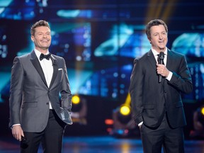 Host Ryan Seacrest, left, and Brian Dunkleman speak onstage during FOX's "American Idol" Finale For The Farewell Season at Dolby Theatre on April 7, 2016 in Hollywood, Calif (Kevork Djansezian/Getty Images)