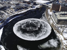 In this Monday, Jan. 14, 2019 aerial image taken by a drone and provided by the City of Westbrook, Maine, a naturally occurring ice disk forms on the Presumpscot River. (Tina Radel/City of Westbrook via AP)
