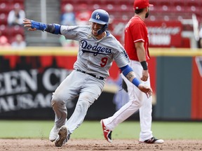 In this Sept. 12, 2018, file photo, Los Angeles Dodgers' Yasmani Grandal advances to second during a game in Cincinnati. (AP Photo/John Minchillo, File)