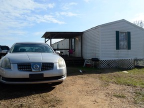 In this Tuesday, Jan. 8, 2019 photo, Ericka Hall's car is parked next to the family's single-wide trailer outside of Magnolia, Miss.