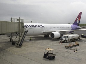 Hawaiian Airlines Flight 45 arrives from San Jose, Calif., in Kahului Airport in Kahului, Hawaii, on Monday, April 21, 2014. (AP Photo/Oskar Garcia)