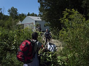 At the end of Roxham Rd. in Champlain, Fiyori Mesfin, 32, crosses into Canada with her three-year-old son and one-year-old daughter, both U.S. citizens.