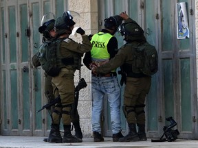 Israeli soldiers detain a cameraman during clashes with Palestinian demonstrators in the occupied West Bank village of Tuqu on January 25, 2019. (MUSA AL SHAER/AFP/Getty Images)