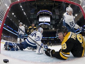 Boston Bruins' David Pastrnak ends up in the crease after scoring against Toronto Maple Leafs goaltender Garret Sparks during the second period of an NHL hockey game Saturday, Nov. 10, 2018, in Boston.