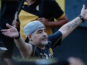 In this Sept. 10, 2018 file photo, former soccer great Diego Maradona says goodbye to the fans in stands, after a training session at the Dorados de Sinaloa soccer club stadium, after Maradona was presented as the new manager of the Dorados in Culiacan, Mexico.