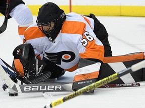Philadelphia Flyers goaltender Mike McKenna reaches for the puck during the second period of the team's NHL game against the Washington Capitals, Tuesday, Jan. 8, 2019, in Washington.