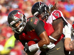 Quarterback Jameis Winston of the Tampa Bay Buccaneers is sacked by defensive end Takkarist McKinley of the Atlanta Falcons at Raymond James Stadium on December 30, 2018 in Tampa. (Will Vragovic/Getty Images)