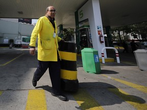 A worker opens his gas station for a few hours until the gasoline runs out again on January 14, 2019 in Mexico City. (Hector Vivas/Getty Images)