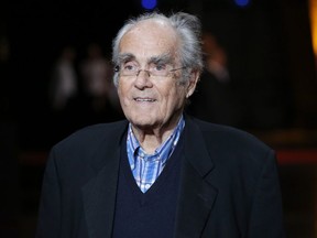 In this Oct. 13, 2014 file photo, French conductor Michel Legrand arrives at the opening ceremony of the 6th Lumiere Festival, in Lyon, France.