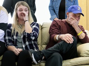 In this Thursday, Jan. 3, 2019 photo, T. Scott Marr and his daughter, Preston Marr, left, break down during a press conference in Omaha, Neb. (Kent Sievers/Omaha World-Herald via AP)
