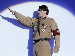 Austrian actor Martin Sommerlatte plays Adolf Hitler making a Nazi salute during the "Springtime for Hitler" number of the musical "The Producers" at Berlin's Admiral's Palast theatre May 14, 2009. (JOHN MACDOUGALL/AFP/Getty Images)