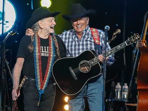 Willie Nelson, left, and George Strait perform at Willie: Life & Songs Of An American Outlaw at Bridgestone Arena on Saturday, Jan. 12, 2019, in Nashville, Tenn.