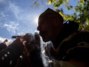 In this file photo taken on October 17, 2018 a man smokes a marijuana cigarette during a legalization party at Trinity Bellwoods Park in Toronto, Ontario. (GEOFF ROBINS/AFP/Getty Images)