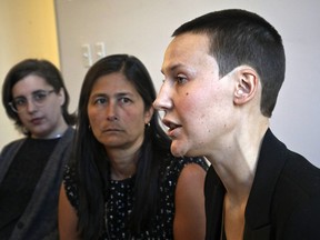 Alison Turkos, right, speaks as Jennifer Welch Demski, left, and attorney Mariann Wang, centre, listen during a news conference to discuss their lawsuit against the New York Police Department for "failing sexual assault victims," Thursday, Jan. 31, 2019, in New York. (AP Photo/Bebeto Matthews)