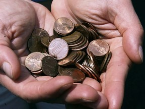 A man shows a handful of pennies in Washington, D.C. (Getty Images)