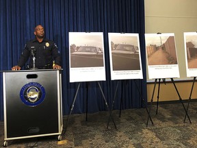 Tempe, Ariz., police Sgt. Ronald Elcock, flanked by photos, some of them video from the body camera worn by the officer who shot the boy who was carrying a replica handgun, talks to reporters in Tempe Friday, Jan. 18, 2019. (AP Photo/Anita Snow)