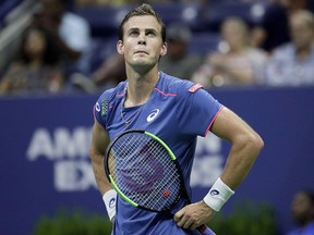 Vasek Pospisil, of Canada, watches a video board while challenging a call at the U.S. Open, Wednesday, Aug. 29, 2018, in New York. (THE CANADIAN PRESS/AP/Julio Cortez)