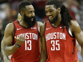 Houston Rockets guard James Harden talks with forward Kenneth Faried late in the second half of an NBA basketball game against the Toronto Raptors, Friday, Jan. 25, 2019, in Houston.