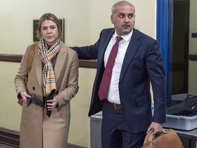 Bassam Al-Rawi, right, accompanied by an unidentified woman, arrives at provincial court in Halifax on Monday, Jan. 7, 2019 for his trial on a charge of sexual assault. (THE CANADIAN PRESS/Andrew Vaughan)
