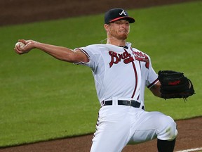 Atlanta Braves starting pitcher Shelby Miller throws after fielding a ball hit for a single by New York Mets' Kelly Johnson in the fourth inning of a baseball game Thursday, Sept. 10, 2015, in Atlanta.