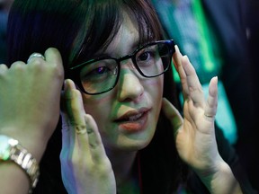 Yumi Dobashi tries on the Focals smart glasses at the North booth at CES International, Wednesday, Jan. 9, 2019, in Las Vegas.