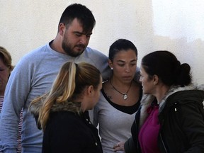 Jose Rosello and Victoria Garcia, the parents of a 2-year-old boy found after falling into a deep borehole 13 days ago, arrive at the cemetery in EL Palo, Malaga, Spain, on Saturday, Jan. 26, 2019.