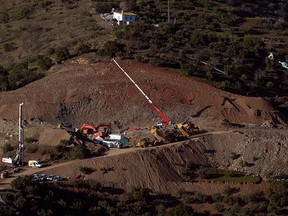 A helicopter of the Spanish Guardia Civil, transporting explosives, prepares to land at the site where a child fell down a well in Totalan, Spain, on January 24, 2019.(JORGE GUERRERO/AFP/Getty Images)