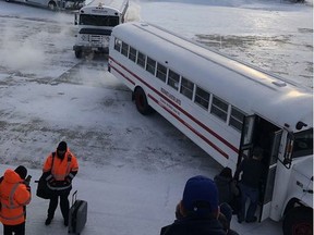 Passengers leave a plane and board buses to change planes in Happy Valley-Goose Bay, N.L., on Sunday, Jan. 20, 2019. An end is finally in sight for passengers who spent about 16 gruelling hours on a plane grounded at an airport in frigid Happy Valley-Goose Bay, Labrador. United Flight 179 from Newark, N.J., to Hong Kong was diverted to the Goose Bay Airport Saturday night after a passenger experienced a medical emergency, according to United Airlines spokeswoman Natalie Noonan. THE CANADIAN PRESS/HO - Sonjay Dutt