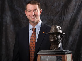 Clemson coach Dabo Swinney poses for a photograph with the Paul "Bear" Bryant Coach of the Year Award, before the ceremony Wednesday, Jan. 9, 2019, in Houston.