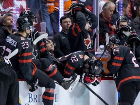 Canada's Alexis Lafreniere (22) hangs his head on the bench after losing to Finland during overtime quarter-final IIHF world junior hockey championship action in Vancouver on Wednesday, Jan. 2, 2019.